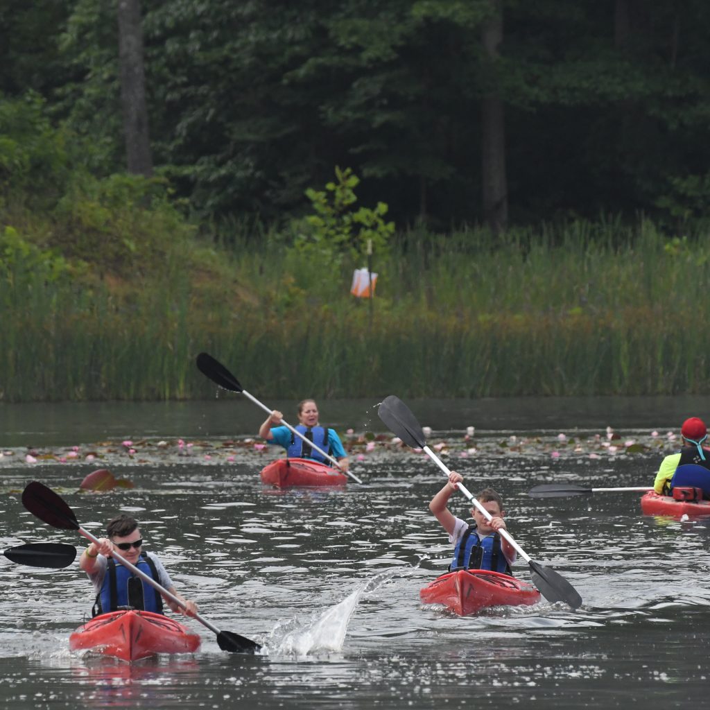 Jamboree participants race across Goodrich like during the 2023 National Scout Jamboree at The Summit Bechtel Reserve in Mount Hope, West Virginia. (BSA Photo by James Chaplin)..**********Beginning of Shooting Data Section**********.20230722-08-45-03-35-JC     date - 7/22/2023     time - 8:45:03 AM.